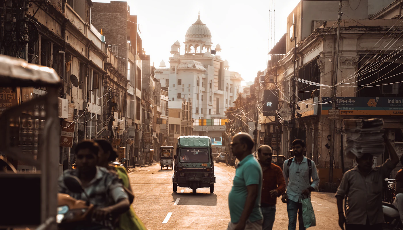 People walking down a sunlit street